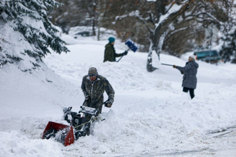 A trio digs out of the Green Mountain neighborhood on November 26, 2019 in Lakewood, Colorado