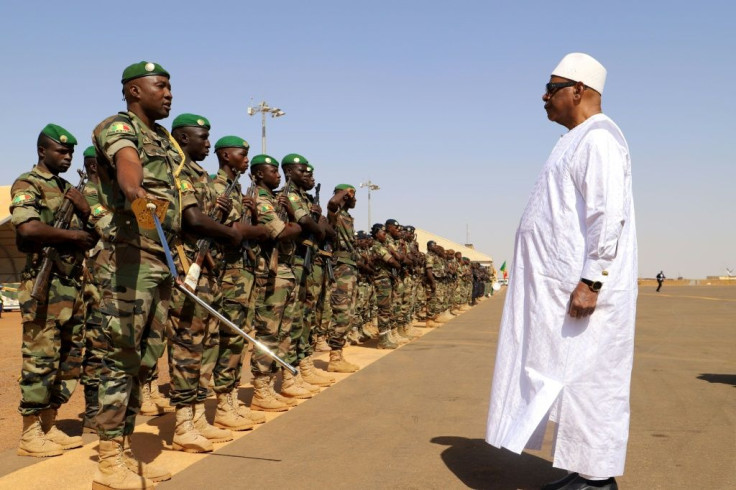 Front line: President Ibrahim Boubacar Keita inspects troops on a visit earlier this month to Gao, in Mali's volatile central region