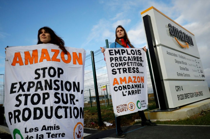 French environmental activists block an Amazon centre in Bretigny-sur-Orge on November 28, 2019, to protest against the company's labour policies and impact on climate change on the eve of  Black Friday.