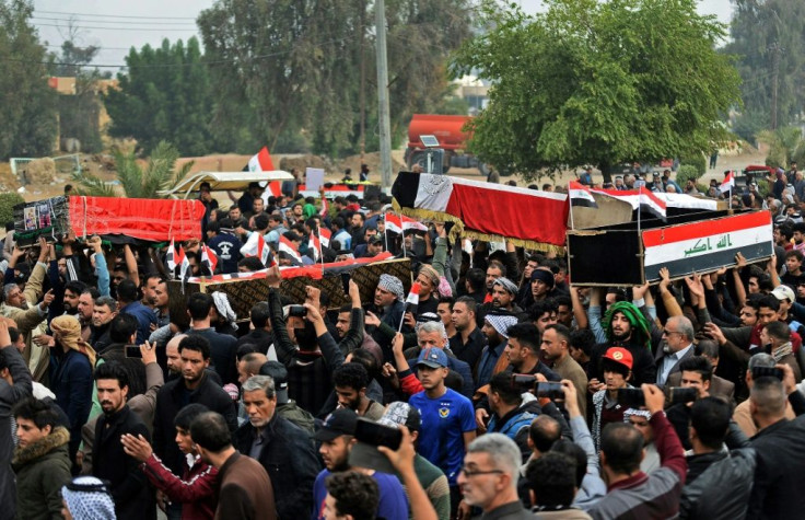 Iraqis carry the coffins of anti-government demonstrators killed during a crackdown on demonstrators in the restive south on Thursday, the single bloodiest day of protests since October 1