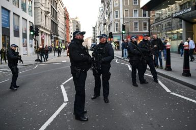 Armed policeman stands guard at Cannon Street station in central London, after several people were injured  and a man detained following a stabbing on London Bridge.