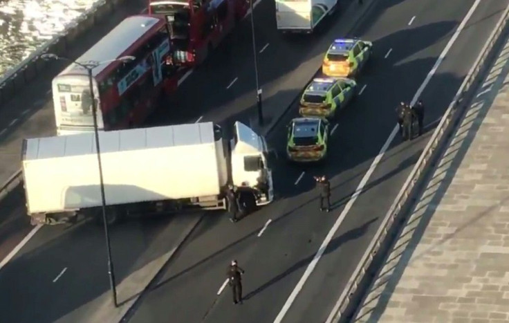 Armed police are shown surrounding a white van jackknifed across London Bridge after the incident