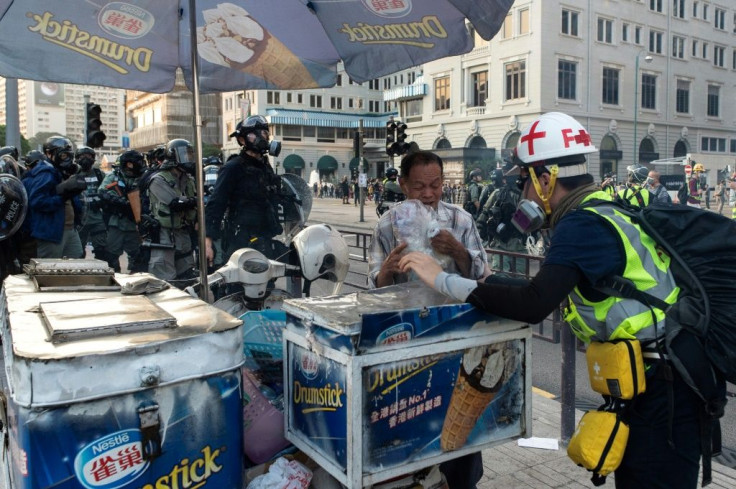 A man selling ice cream was caught in the crossfire as police fired tear gas at protesters