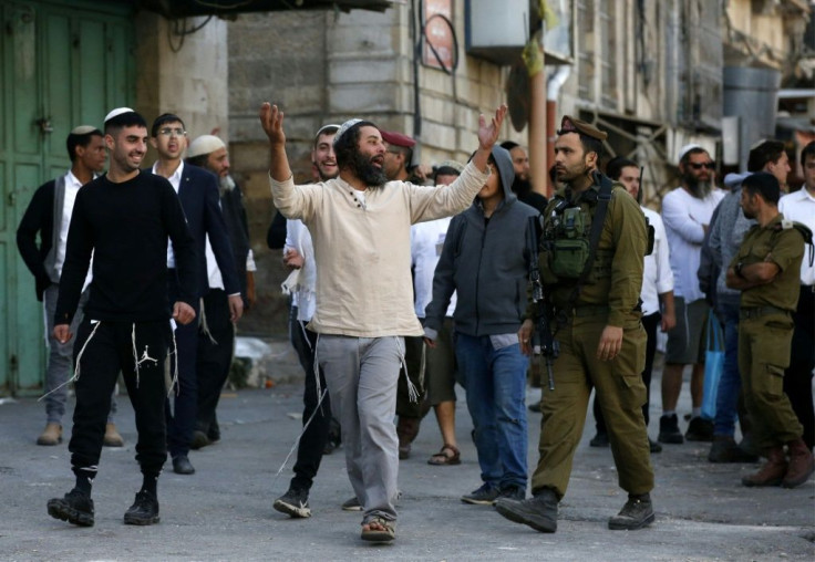 Israeli settlers in Hebron are protected by a strong presence of security forces