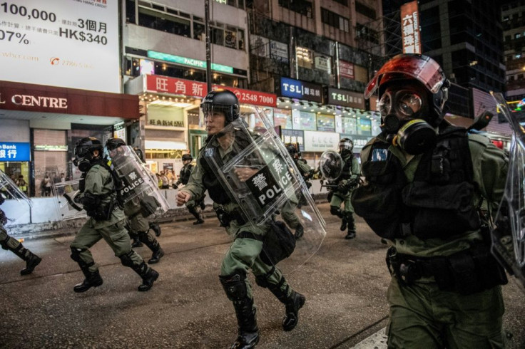 Hong Kong riot police fired tear gas and pepper spray as tens of thousands of protesters flooded into the streets one week after pro-democracy candidates scored a landslide in local elections