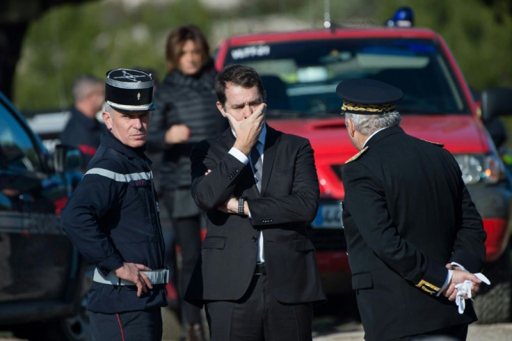 Interior Minister Christophe Castaner confers with local prefect Pierre Dartout as he is briefed on the helicopter accident and the flooding