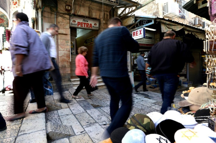 People walk past the Petra guest house located next to Jaffa Gate in the Christian quarter of Jerusalem's Old City, one of three disputed properties allegedly sold to an Israeli settlers association