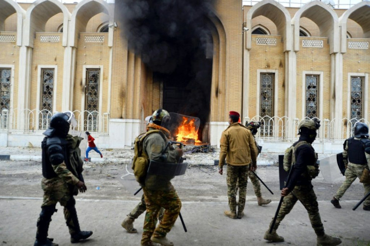 Smoke billows from a shrine in the Shiite holy city of Najaf dedicated to the late Ayatollah Mohammed Baqir al-Hakim, who founded one of Iraq's main Shiite political parties