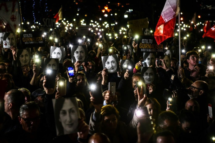 Maltese journalist Daphne Caruana Galizia, seen here protesters' photos, was killed by a carbomb in 2017