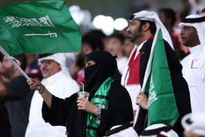 Vocal minority: Saudi supporters wave their national flag as their team defeat Qatar in the Gulf Cup semi-finals