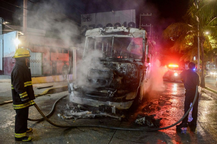 Firefighters work after a bus was set on fire in Mexico's tourist hub of Acapulco