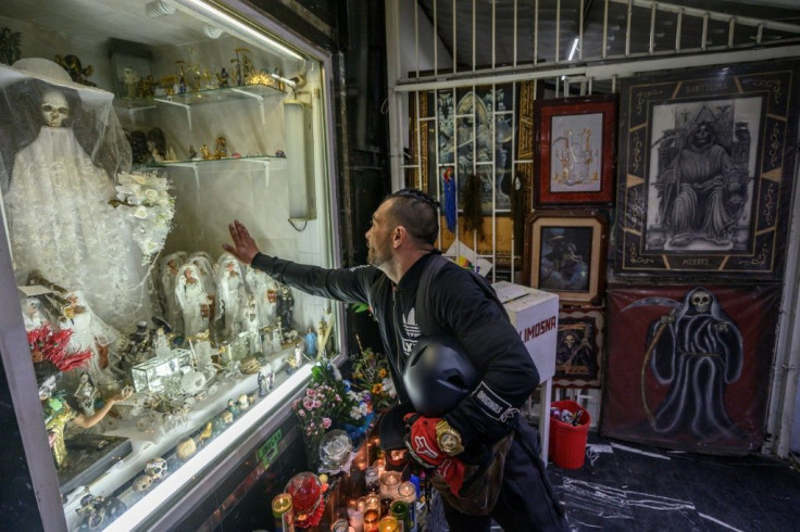 A devotee prays at an altar to Santa Muerte (Our Lady of Holy Death) in Mexico City's dangerous Tepito neighborhood