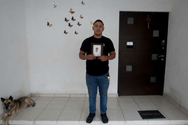 Ricardo Rivera holds a picture of his missing brother in the northern industrial city of Monterrey