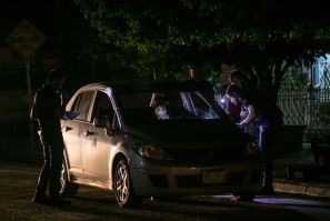 Experts work at a crime scene where a man was shot dead in Culiacan -- the victim is inside the car
