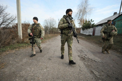 Ukrainian servicemen patrol in the streets of the village of Katerynivka, in the Lugansk region. The conflict in eastern Ukraine has been raging since 2014