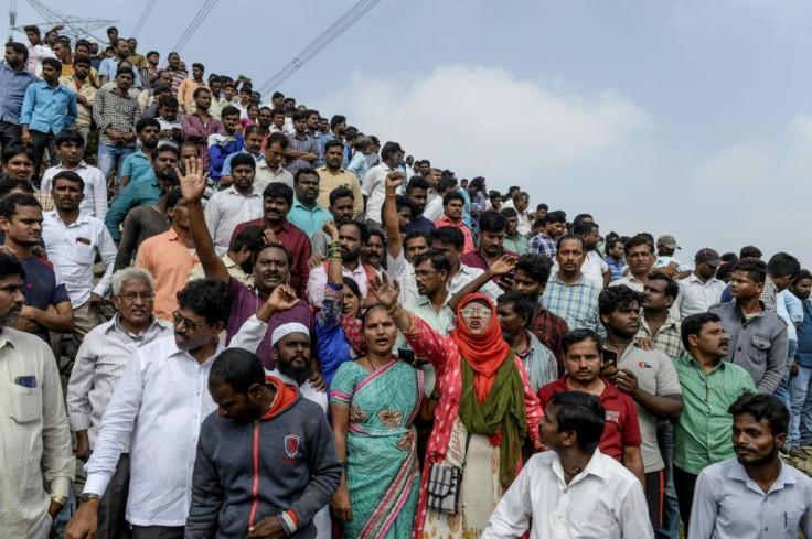 Several hundred people flocked to the scene of the men's deaths on Friday, setting off firecrackers to celebrate and showering police with flower petals