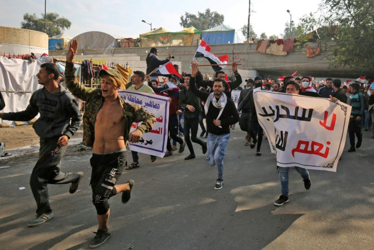 Iraqi supporters of the Iran-trained Hashed al-Shaabi paramilitary force join protesters in Baghdad's Tahrir Square in what is widely seen as an act of intimidation