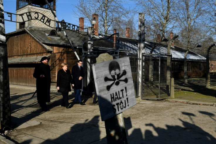 Angela Merkel was accompanied by Polish Prime Minister Mateusz Morawiecki (R) as she walked through the gates at Auschwitz