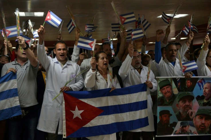 Doctors wait for fellow medical personnel returning from Bolivia at the Jose Marti International airport in Havana on November 16, 2019