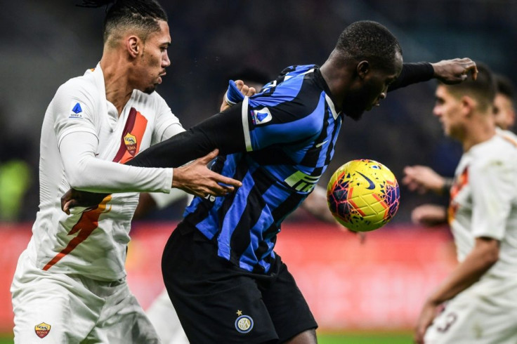 AS Roma defender Chris Smalling holds off Inter Milan forward Romelu Lukaku
