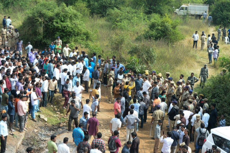 Several hundred people flocked to the scene where Indian police shot dead four gang-rape and murder suspects, showering police with flower petals