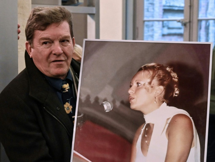 Jacky Kulik holds a portrait of his daughter Elodie who was kidnapped, raped, strangled and her corpse then burned in northern France in January 2002