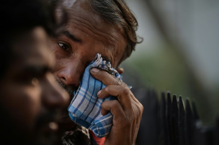 Outside a nearby hospital morgue, anxious relatives and friends gathered to search for bodies