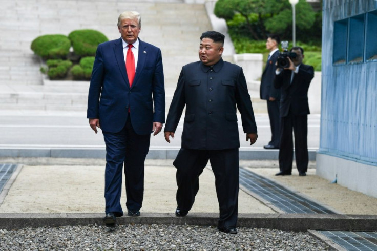 North Korea's leader Kim Jong Un and US President Donald Trump cross south of the Military Demarcation Line that divides North and South Korea, after Trump briefly stepped over to the northern side, on June 30, 2019