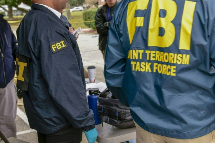 Joint Terrorism Task Force personnel on the site of a shooting rampage at a naval base in Pensacola, Florida