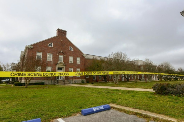 Police tape stretching across a street near a building after a shooting at the Pensacola Naval Air Station in Florida on December 6, 2019