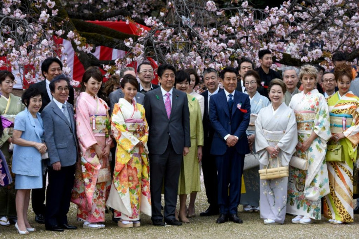 Japanese Prime Minister Shinzo Abe (C), pictured here at 2015's cherry blossom party, has already weathered two cronyism scandals in recent years