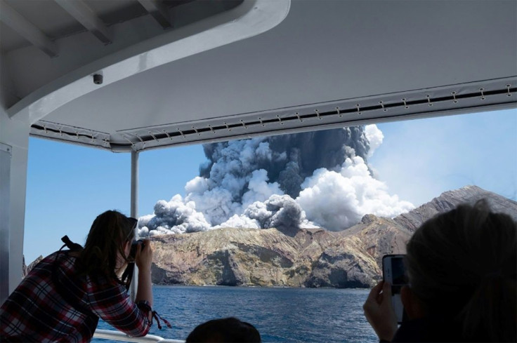 A photo courtesy of Michael Schade shows the volcano on New Zealand's White Island spewing steam and ash moments after it erupted