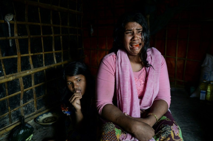 Dildar Begum, with her daughter, says Myanmar soldiers killed her husband and two young sons