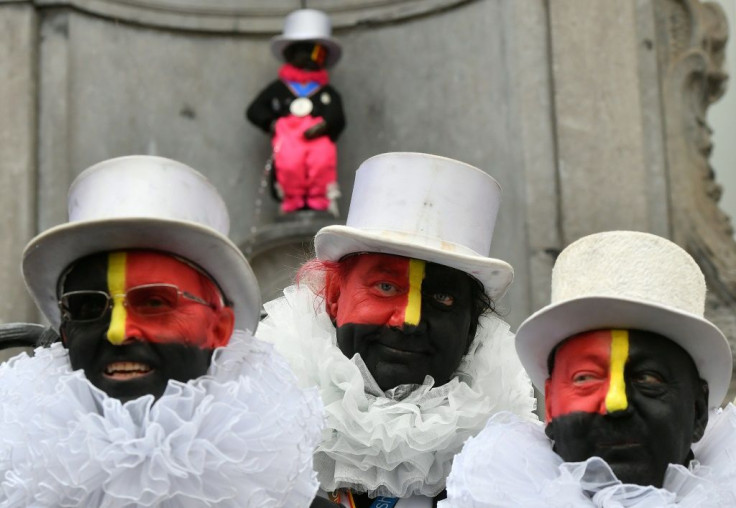 Belgians are used to political stalemate and most seem happy to get on with life without a government, seen here members of the Noirauds (Blackies) community association pose in national colours in front of the Mannekin Pis sculpture