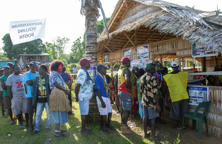 People queue to vote at a polling station in the capital Buka in an historical independence vote on November 25, 2019.
