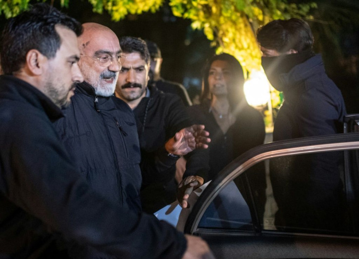 Journalist and writer Ahmet Altan (C) is led to a car by Turkish police after he was detained on November 12 in Istanbul