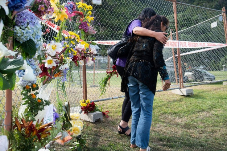 Bouquets of flowers are placed on the waterfront near the White Island Tours base in Bay of Plenty, New Zealand on December 10, 2019, in memory of those who lost their lives in the volcano eruption