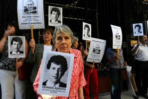 Beatriz Cantarini de Abriata holds a portrait of her son Hernan, who is believed to have been the victim of the "butcher" of Argentina's dictatorship Mario Sandoval, who has been arrested in France