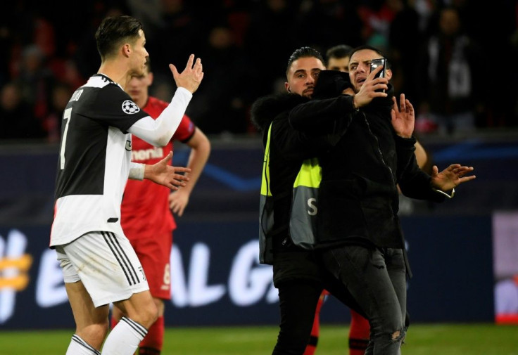 Close call: Cristiano Ronaldo berates a pitch invader who wanted a selfie with the Juventus star