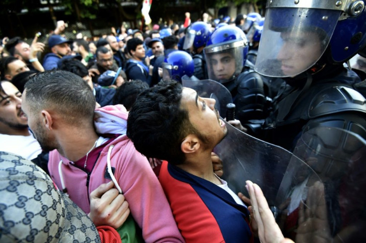 Algerian protesters scuffled with security forces during an anti-government demonstration in the capital Algiers on the eve of the election