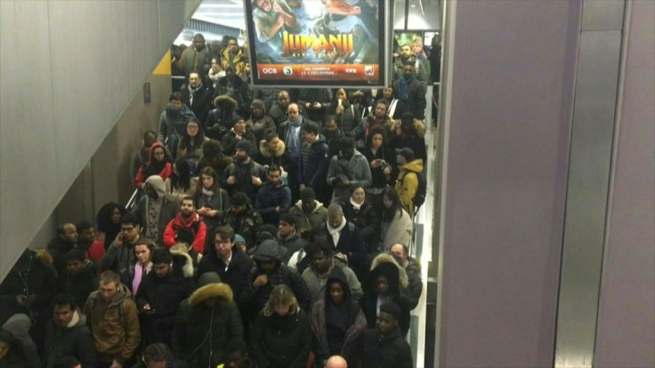 Commuters rush to board overcrowded trains to the Paris suburbs during rush hour