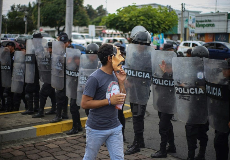 An anti-government protester wears a mask depicting Nicaraguan President Daniel Ortega on October 31, 2019