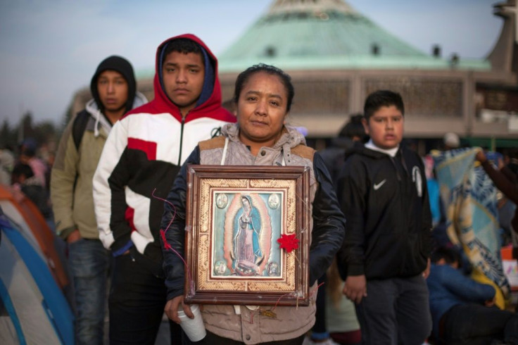 Pilgrims with their image of the Virgin of Guadalupe at the cathedral in Mexico City