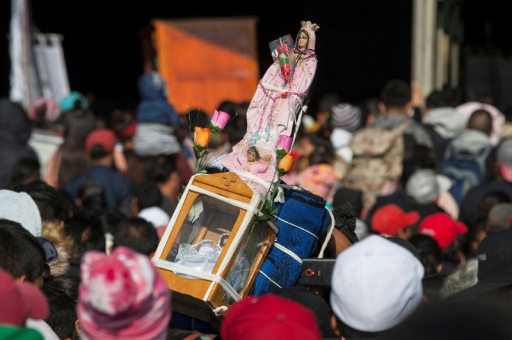 Faithful, with a statue of the Virgin of Guadalupe on their shoulders head to her basilica