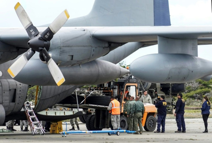 Chilean military personnel on December 13, 2019 offload the landing gear from the Hercules C-130 air force plane that crashed on its way to Antarctica, killing all 38 people on board