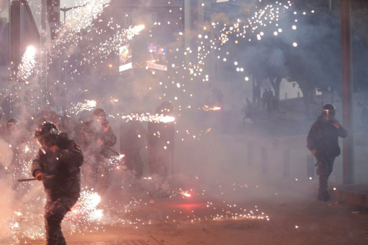 Lebanese counter-protesters threw firecrackers at riot police in central Beirut