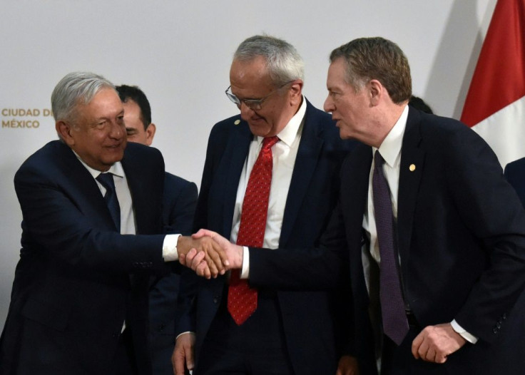 Mexican President Andres Manuel Lopez Obrador (L) shakes hands with US Trade Representative Robert Lighthizer as Mexico's Jesus Seade looks on at the trade pact signing on December 10, 2019 in Mexico City; labor monitoring later became an issue