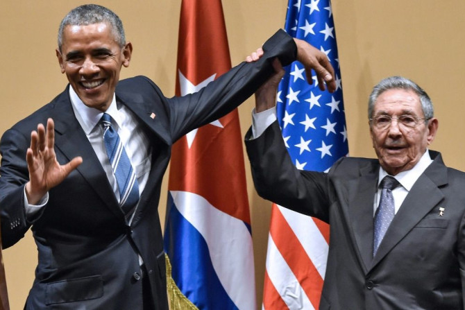 Cuban president Raul Castro raises US president Barack Obama's hand in Havana on March 21, 2016