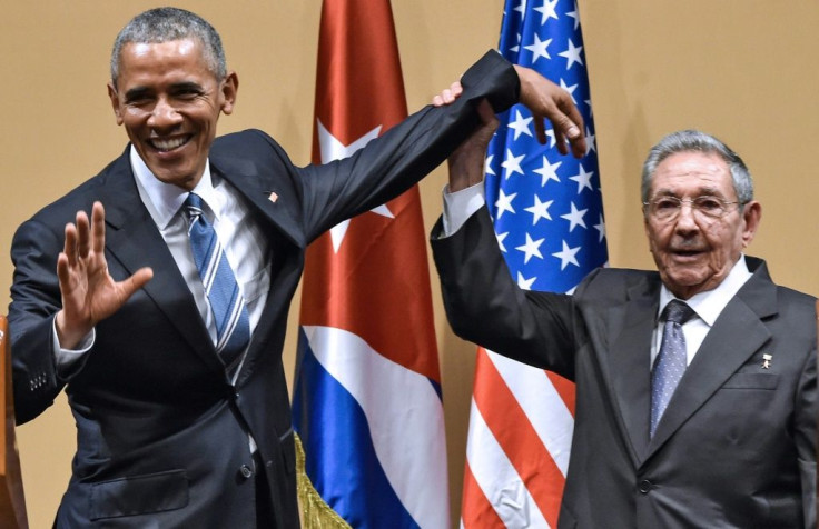 Cuban president Raul Castro raises US president Barack Obama's hand in Havana on March 21, 2016