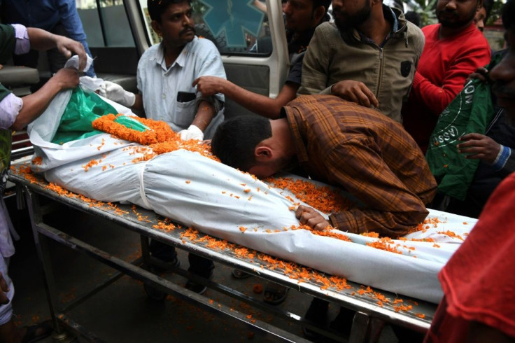 A relative mourns next to the dead body of Iswor Nayak, 25, who was killed after police fired during a protest against the government's citizenship law in Guwahati